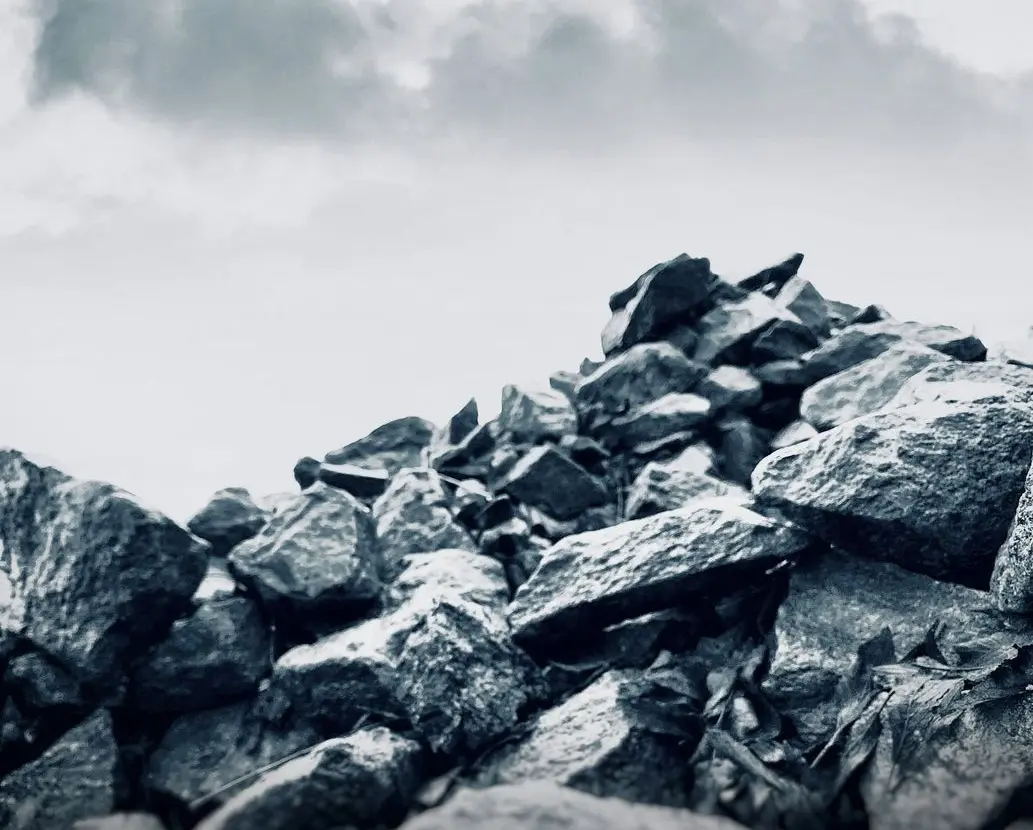 rocky mountain under white clouds during daytime
